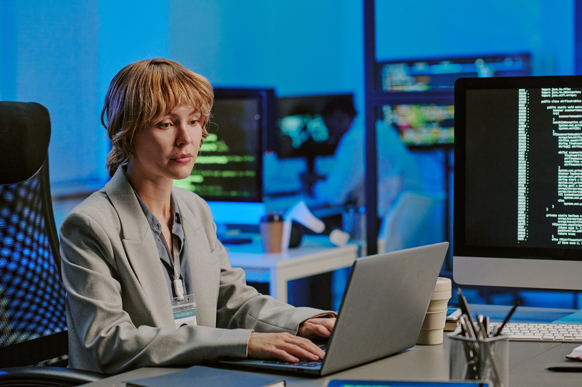 Young Woman Typing On Laptop In Cybersecurity Office